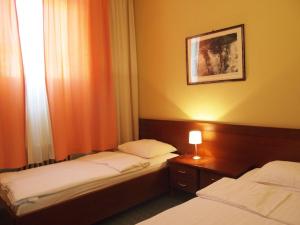 Postel nebo postele na pokoji v ubytování Hotel Central