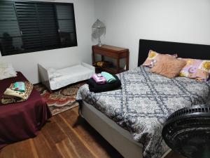 a bedroom with a bed with pillows on it at Pousada Canto dos Pássaros in Cianorte