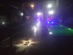 a night time picture of a swimming pool with lights at Villa tagmouti in Aghmat