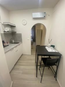 a kitchen with a black table and a dining room at Da Mariolino in Arezzo