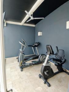 a gym with three exercise bikes in a room at Loft Downtown CDMX Reception & luggage in Mexico City
