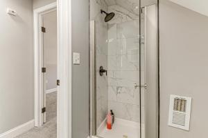 a shower with a glass door in a bathroom at 4 Mi to Universities Quaint Parkville Apartment! in Parkville +19 photos