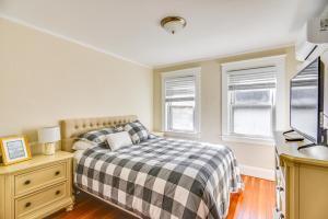 a bedroom with a bed and a desk and two windows at Lovely Westerley Home with Yard and Grill! in Westerly