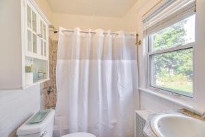 a bathroom with a white shower curtain and a window at Lovely Westerley Home with Yard and Grill! in Westerly +27 photos