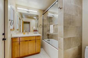 a bathroom with a tub and a sink and a toilet at Windrow Retreat in Sea Ranch +12 photos