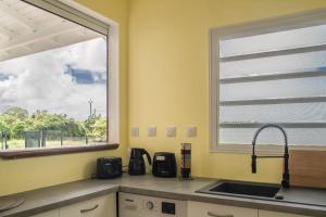 a kitchen with a sink and a window at Villa Aura in Grand-Bourg