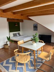 a room with a table and chairs and a bed at Cozy loft with a view, central, close to tradefair in Düsseldorf +31 photos