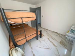 a bunk bed in a room with a marble floor at Casa entera gran ubicación, aeropuerto ver in Veracruz