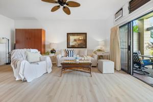 a living room with white furniture and a ceiling fan at Kapalua Ridge Villa 2712 in Kapalua