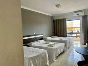 Postel nebo postele na pokoji v ubytování Oasis Praia Hotel
