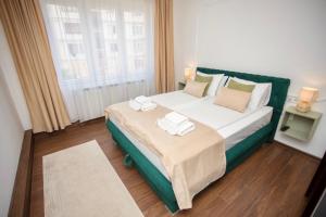 a bedroom with a large bed and a window at Mak Apartment - free parking - balcony in Sarajevo
