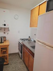 a kitchen with a white refrigerator and a sink at Hermoso dpto en el corazón de Belgrano in Buenos Aires