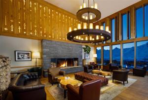 a lobby with couches and a fireplace with mountains at Frutt Mountain Resort in Frutt +155 photos