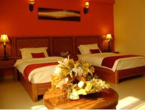 Ένα ή περισσότερα κρεβάτια σε δωμάτιο στο La Rosa Hotel By Brother International