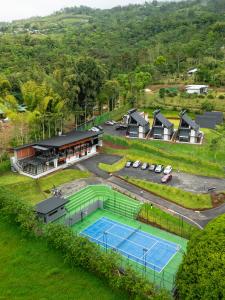 an aerial view of a tennis court and a house at Villa Bosque CR in Turrialba