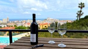 a bottle of wine and two glasses on a table at Blu Mare apartment in Peñíscola