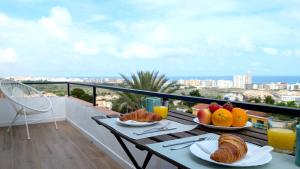 a table with plates of food on top of a balcony at Blu Mare apartment in Peniscola