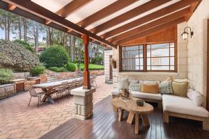 a patio with a couch and a table at Casa Queenie in Picketts Valley
