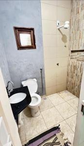 a bathroom with a toilet and a sink at Pousada riacho santa cruz in Barreirinhas +26 photos