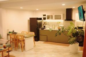a kitchen with a table and a refrigerator at Yana house Tuy Hoa in Tuy Hoa
