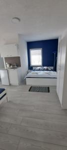 a bedroom with a bed and a blue wall at Villa Sofijana in Ohrid