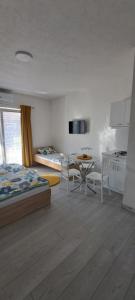 a bedroom with a bed and a table and chairs at Villa Sofijana in Ohrid