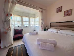 a bedroom with a large bed with two towels on it at Evalacati - Villa Palma-Tamamen Müstakil Villa in Cesme +54 photos