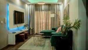 a living room with a green couch and a table at Prainha Beach Apartments - Walk to Prainha Beach - AC - Fast WiFi - Easy Check-in in Praia