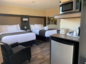 Postel nebo postele na pokoji v ubytování Cairns Motel