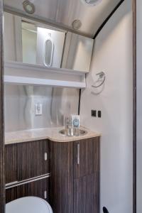 a bathroom with a sink and a mirror at Mt Hood Log Cabin! Fresh Remodel with Airstream 2 in Mount Hood Village