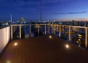a balcony with a view of a city at night at Tabist TOKYO CITY VIEW HOTEL in Tokyo