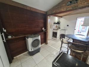 a kitchen with a table and a room with a heater at kitnet in Petrolina