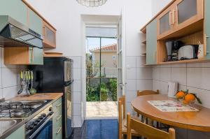 a kitchen with a table and a counter top at Apartments by the sea Orebic, Peljesac - 24372 in Orebić