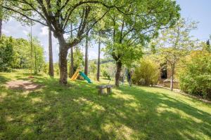 a park with a bench and a playground at Monolocale in Radicondoli