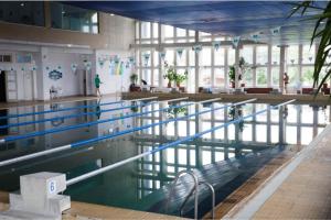 a large swimming pool in a large building at Studio Fortuna Park Residence in Sfântu-Gheorghe