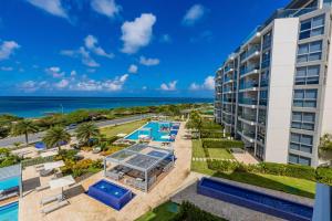 an aerial view of a resort with a pool and the ocean at Azure Beach Residences in Palm-Eagle Beach