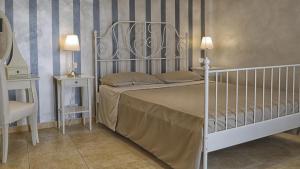 a bedroom with a white bed and two night stands at Relais La Pretura in Vieste +81 photos