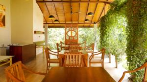 a dining room with a table and chairs at Sidh Sigiriya in Sigiriya