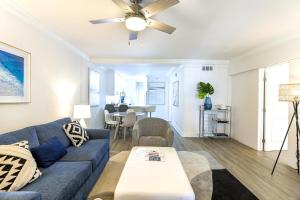 a living room with a blue couch and a table at Boca Waterfront with Pool, Gym, Parking and Short Walk to the Beach in Boca Raton