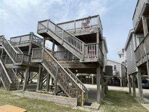 a stack of wooden stairs in front of a building at NC 12 56821-18 Condo in Hatteras
