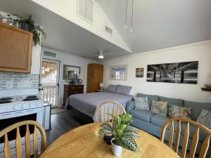 a living room and kitchen with a bed and a couch at NC 12 56821-18 Condo in Hatteras