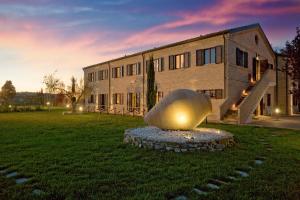 a large building with a large sculpture in front of it at Villa Gens Camuria in Camerano