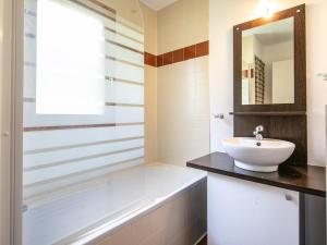 a bathroom with a tub and a sink and a mirror at Chalet with shuttle bus in Gresse in Gresse-en-Vercors +25 photos
