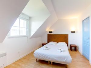 a bedroom with a white bed and a window at Apartment in Brittany near Pentrez Beach in Saint-Nic +23 photos