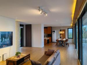 a living room with a couch and a table at The LakeFront Villa in Binangonan