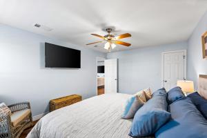ein Schlafzimmer mit einem Bett und einem Deckenventilator in der Unterkunft Holiday Hideaway in Bolivar Peninsula