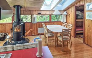 a kitchen and dining room with a wood stove at 2 Bedroom Gorgeous Home In Ebeltoft in Ebeltoft