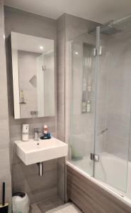 a bathroom with a sink and a shower at Luxury living London -colindale garden single room in Colindale