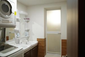 a white bathroom with a sink and a microwave at M2-3Haneda Lex House 9BDR Max22 people 2WC 2Bath 1min from Sta FreeParking 'Private use in Tokyo +39 photos