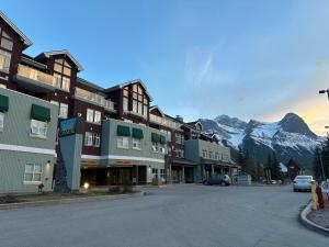 a street in a town with a mountain in the background at Canmore Mountain View Escape in Canmore